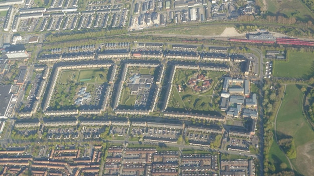 An aerial view of a developing urban neighborhood with new residential buildings and commercial spaces, showcasing potential for real estate investment.