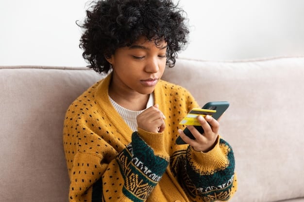 A person using a phone, with a friendly expression, while looking at notes, representing a calm and prepared approach to negotiating with a credit card issuer.