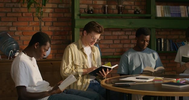 A diverse group of students are working on tablets and computers in a modern classroom, collaborating on a project.