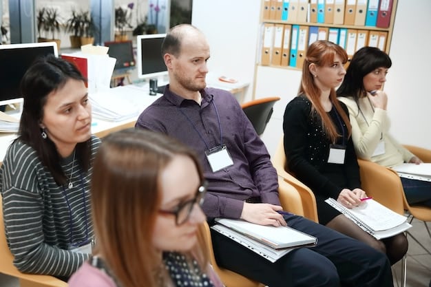A group of teachers are participating in a professional development workshop. They are engaged in a hands-on activity, using laptops and other materials. The facilitator is a seasoned educator who is guiding the teachers through the session. The atmosphere is collaborative and focused on learning.