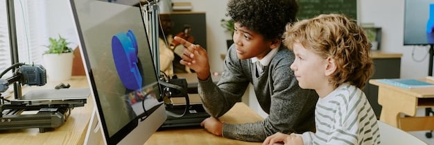 A teacher guiding a student through a coding project, with computers and programming interfaces visible.