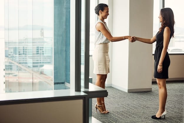 A person confidently shaking hands with a potential employer in a bright and modern office setting, symbolizing the culmination of successful networking efforts.