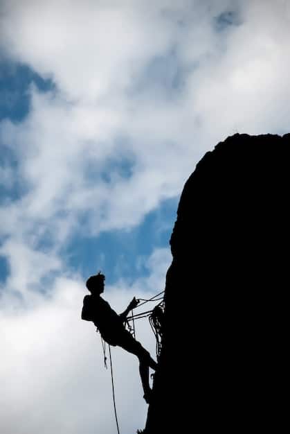 A person climbing a mountain, symbolizing overcoming obstacles and achieving goals through perseverance.