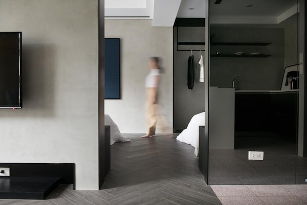 A modern hotel room designed for accessibility, featuring a spacious layout, grab bars in the bathroom, a roll-in shower, and a lowered sink. The room is well-lit and inviting, emphasizing comfort and convenience for travelers with disabilities.