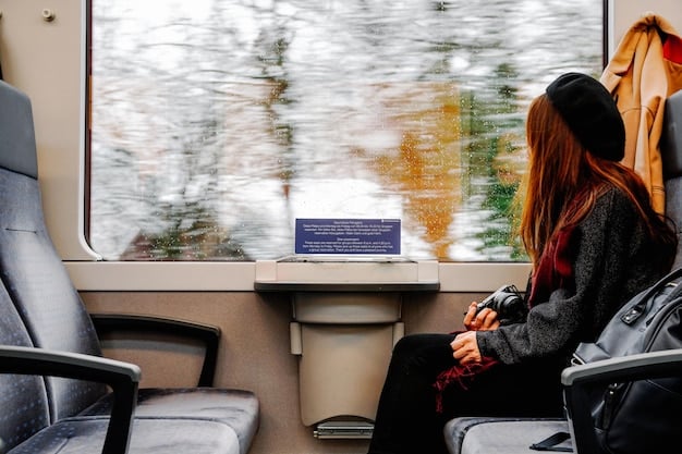 Inside a modern Amtrak train, showing comfortable seating arrangements with ample legroom. Passengers are seen reading, working on laptops, and gazing out the window.