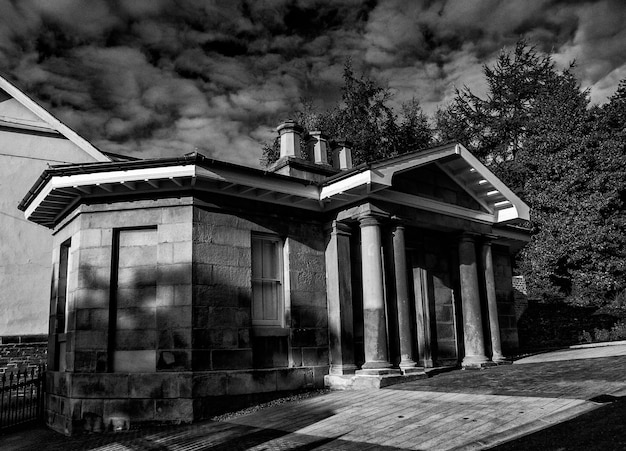 A black and white photograph of a historical landmark which could be an old court house.