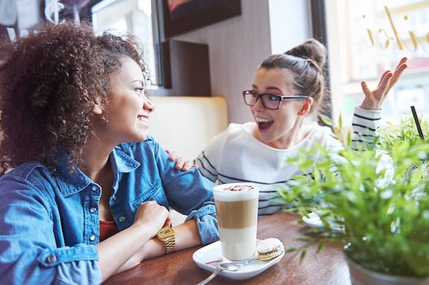 A closeup of two people engaged in conversation, showing positive body language like eye contact and smiling. The setting is a coffee shop, suggesting a casual and friendly environment.