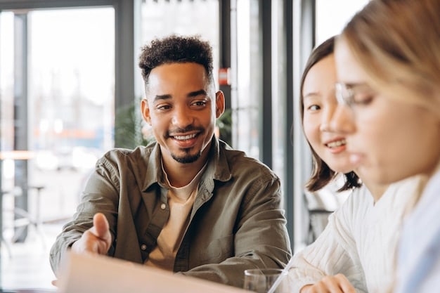 A person smiling and confidently interacting with colleagues during a meeting in modern office, showcasing the American emphasis on self-reliance and professionalism.