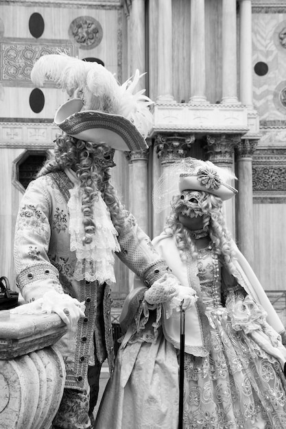 A black-and-white photograph depicting a scene from a 19th-century opera house, with elegantly dressed patrons, highlighting the historical association of culture with high society and refined arts.