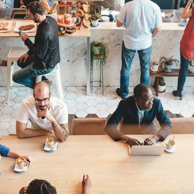 Three digital nomads working collaboratively at a large wooden table in a co-working space. They are looking at a laptop screen, discussing ideas, and smiling. The space is bright and modern, with plants and colorful artwork.