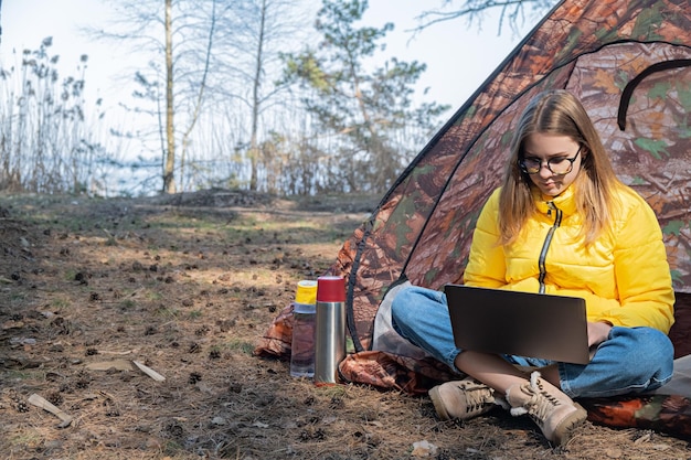 A campsite in Zion National Park with a laptop and portable Wi-Fi hotspot setup. The image shows a digital nomad working outdoors under the starry night sky, highlighting the blend of technology and nature.