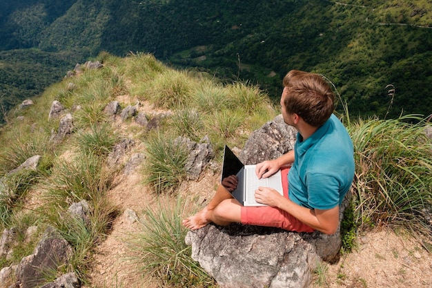 A digital nomad taking a break from work to hike a trail in the Rocky Mountain National Park. The photo emphasizes the balance between work and outdoor activities, showing the scenic beauty of the park.