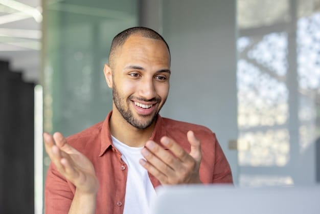 A person participates in a video conference call in a modern co-working space, smiling and engaged with the conversation.