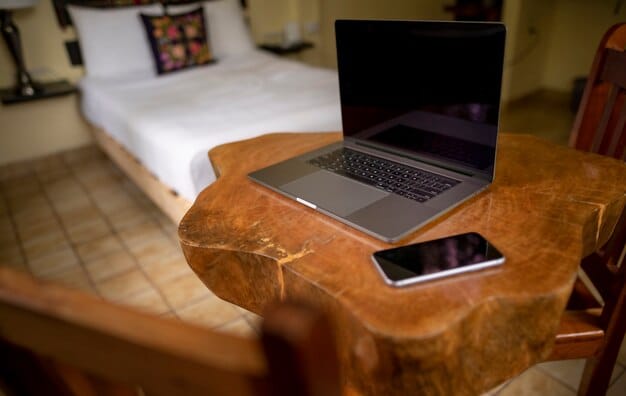 A close-up shot of a laptop on a desk in a beautifully decorated Airbnb room, highlighting the fast internet speed test result on the screen. Cables and chargers are neatly organized.