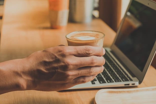 A close-up shot of a digital nomad's hands typing on a laptop, with a coffee cup and passport visible in the background. The focus is on the laptop screen, which shows a LinkedIn profile being updated with a new blog post. This image represents the daily activities involved in managing a personal brand while traveling.