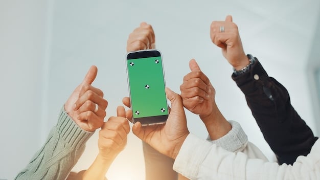 A close-up shot of a hand holding a smartphone displaying a social media post celebrating individual success, contrasted by a blurred background of team members working together in a conference room.