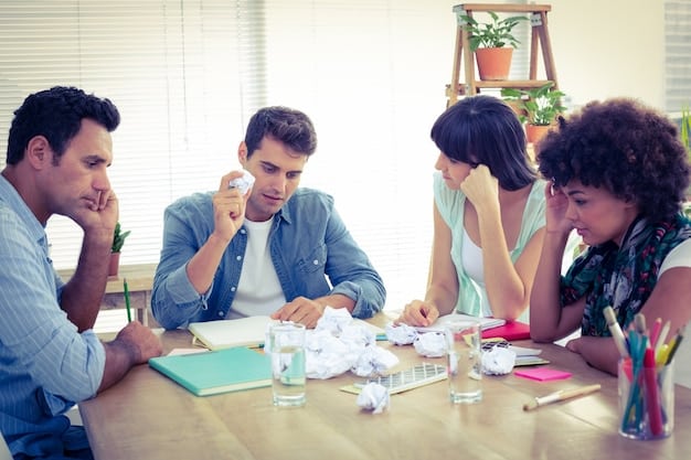 People sitting around a table brainstorming and throwing out ideas.